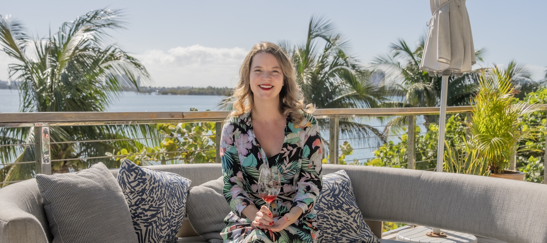 Amanda Barnes MW in Miami, a glass of rosé in hand